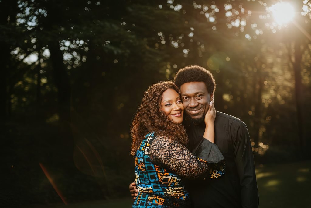 Couple embracing in golden sunlight.